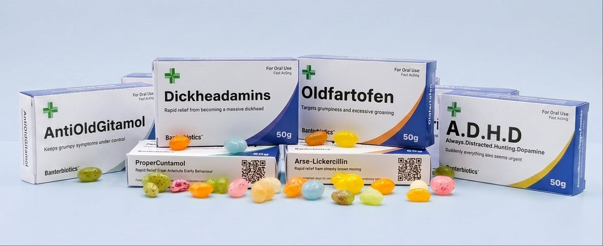 Five funny pharmaceutical product boxes arranged on a light blue studio background, with small multicolored capsules or pills scattered in front. Visible text includes AntiOldGitamol, Dickheadamins, Oldfartofen, ProperCautamol, Arne-Lukerollin, and A.